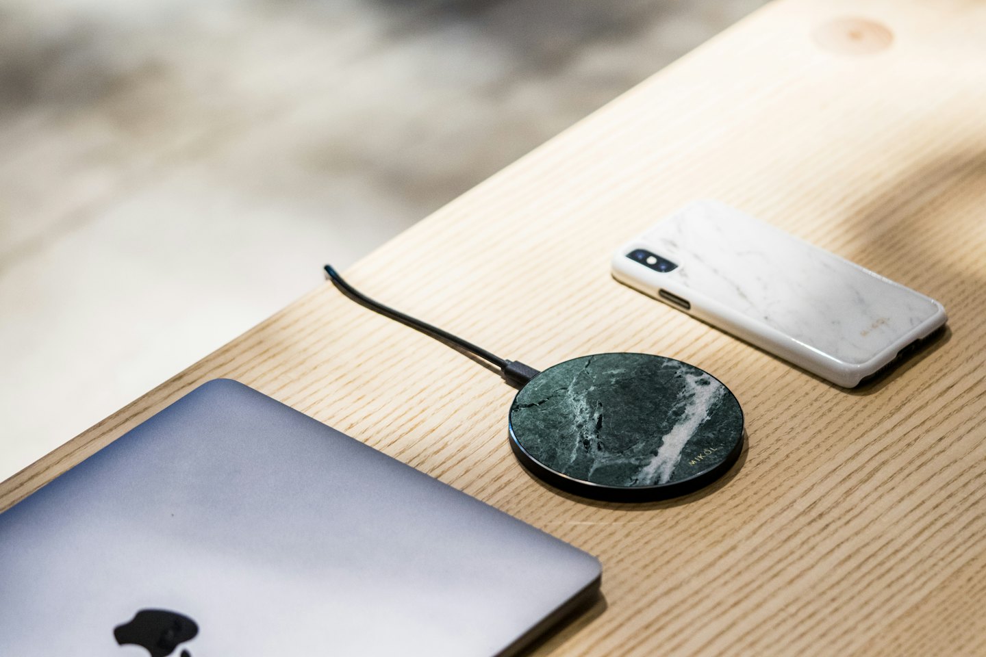 Modern tech accessories on a light wood desk.